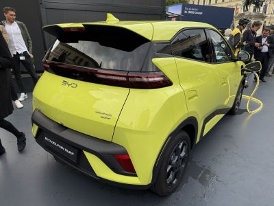 Rear view of electric hatchback charging with sleek tail lights