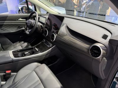 Detailed modern car dashboard with widescreen display and steering wheel