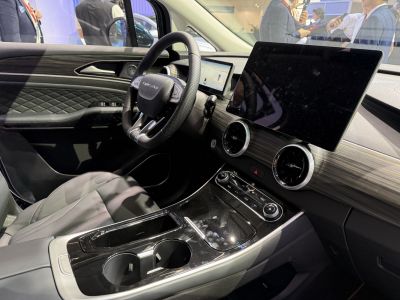 Leather steering wheel, dual touchscreens, woodgrain dashboard, modern control panel