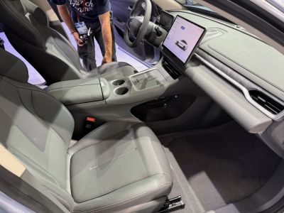 Bright car interior with large touchscreen and spacious front seats