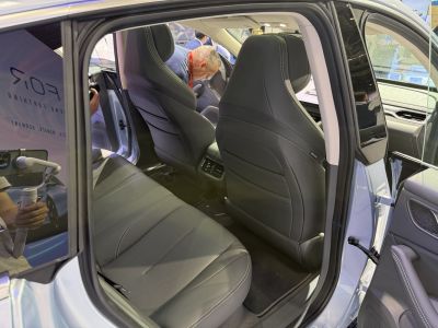 Spacious rear seats with premium leather upholstery and stitching detail.