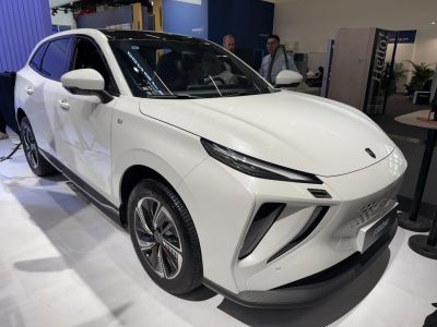 Sleek front and side of white electric SUV with modern headlights and alloy wheels