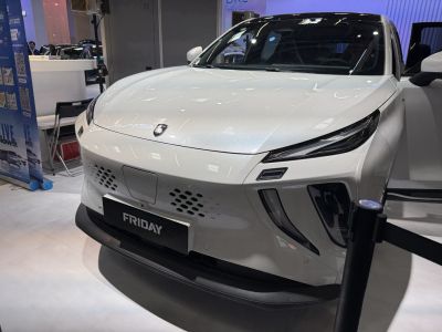 Front view of an electric car with sleek LED headlights and aerodynamic design