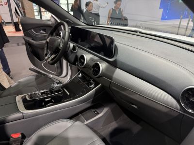 Wide digital dashboard, circular air vents, center console with gear shift