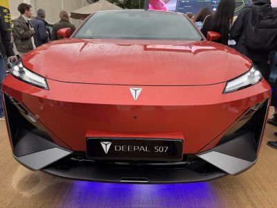 Front view of a red vehicle with LED headlights and sporty bumper design