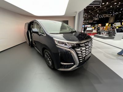 Luxurious minivan front grille and open sliding side door