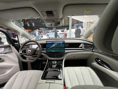 Modern car interior with digital dashboard and large touchscreen.