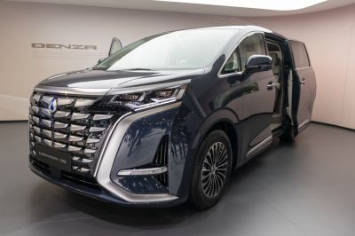 Luxury minivan front grille with distinctive headlights and open sliding door