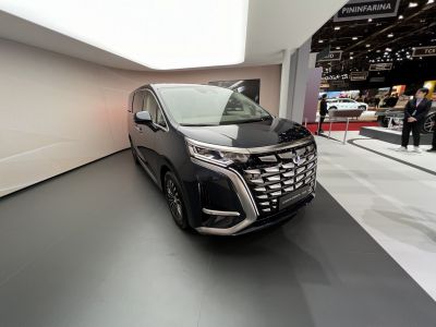 Luxury minivan front with detailed grille and LED headlights