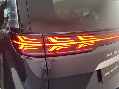 Close-up of modern LED taillight with dynamic pattern.