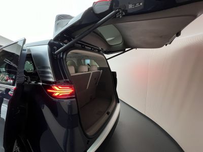 Open rear trunk and LED tail light of a modern SUV.