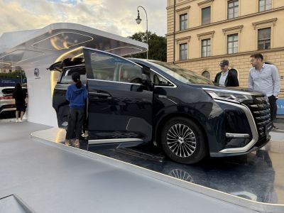 Black minivan with open sliding door and modern alloy wheels