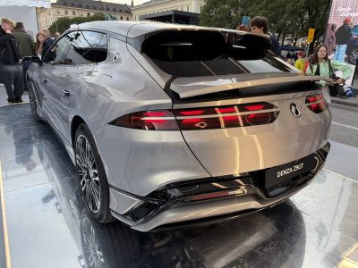 Rear view of sleek silver electric hatchback with LED taillights and spoiler