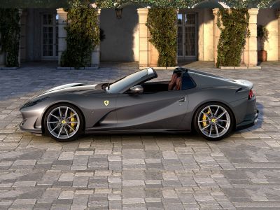 Side profile of a convertible sports car with aerodynamic design and yellow brake calipers.