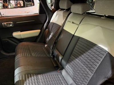 Quilted patterned two-tone leather rear seats with seatbelt and door panel.