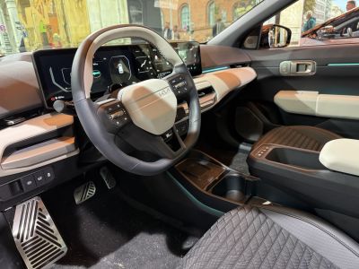 Modern electric hatchback interior with digital dashboard and multifunction steering wheel