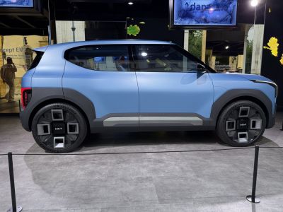 Electric compact SUV with futuristic geometric wheel design and aerodynamic body.