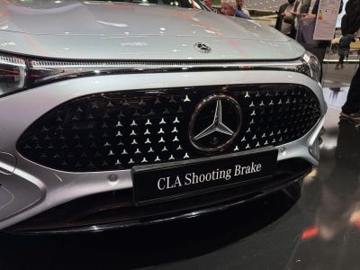 Close-up of car front grille with emblem and badge