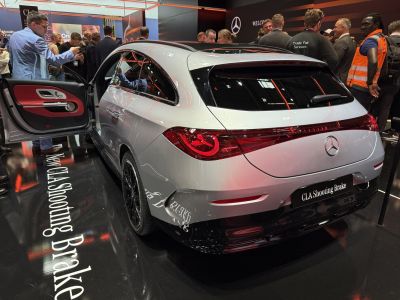 Rear view with illuminated taillights and open driver door interior