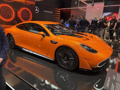 Aerodynamic hood vents and black multispoke alloy wheels on a sleek sport sedan