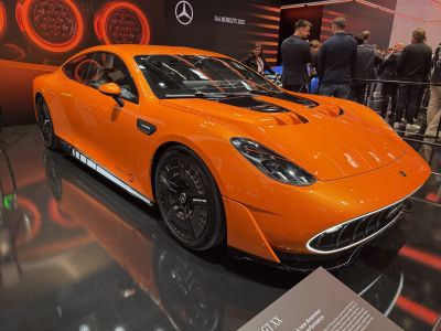 Orange electric sports sedan, aerodynamic design, AMG wheels