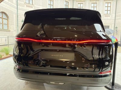 Sleek rear view with continuous LED tail light bar and embossed model name.