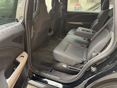 Spacious and luxurious rear seat interior with premium materials and cup holders