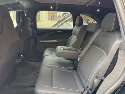 Spacious rear seating with armrest and cup holders in luxury interior