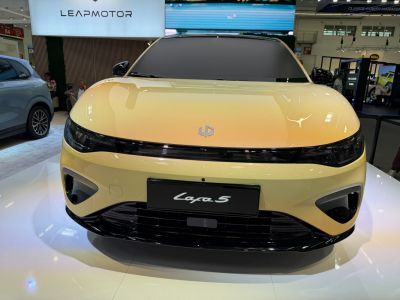 Front view of electric sedan with LED headlights and aerodynamic hood