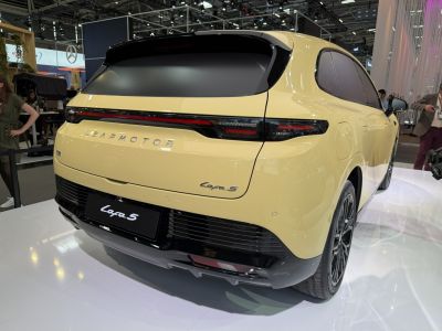 Rear view of a modern electric SUV with sleek tail lights and black trim.