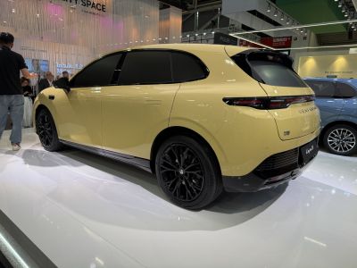 Rear and side view of a sleek hatchback with black alloy wheels