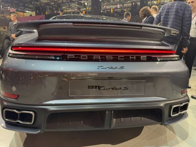 Rear view of sports car with light bar, spoiler, and quad exhausts