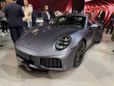 Front and side view of a sleek sports coupe with distinctive LED headlights and aerodynamic details