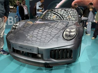 Front view of sleek 2024 sports car with distinctive headlights and aerodynamic intakes