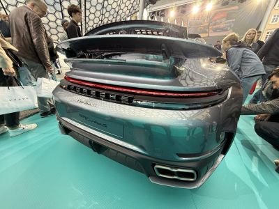 Rear view with active rear wing and distinctive dual exhausts