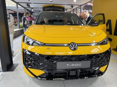 Front grille and LED headlights of a yellow modern SUV