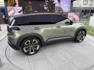 Sleek SUV side profile with aerodynamic wheels and tinted windows.