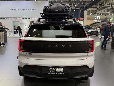 Rear view of compact SUV with roof rack and luggage