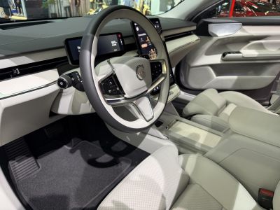 Modern steering wheel and digital instrument cluster in luxury car interior