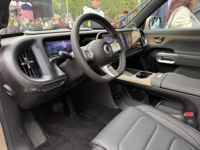 Digital dashboard and steering wheel with wood trim and ergonomic cockpit design