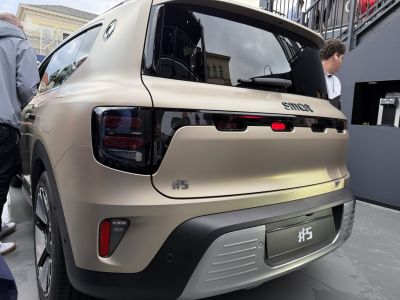 Rear view of electric SUV with distinctive tail lights and #5 badge