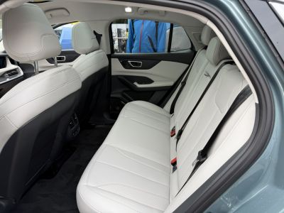Spacious, modern rear seating with light upholstery and ergonomic design