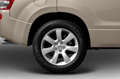 Close-up of rear alloy wheel with Dunlop Grandtrek tire on SUV