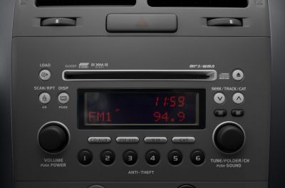 Close-up of car audio system with CD slot and digital display