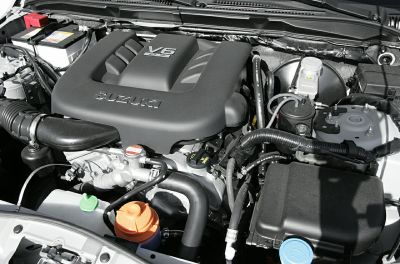 V6 engine bay with intake, fluid reservoirs, and engine cover