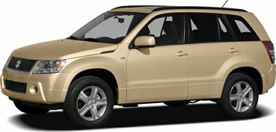 Front side view of a beige V6 3-door mid-size SUV with alloy wheels