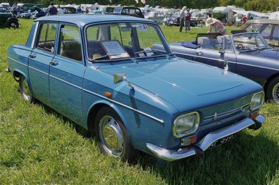 Vintage blue four-door sedan with chrome bumpers and retro side mirrors