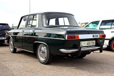 Rear view of a classic car with chrome bumpers and rectangular tail lights.