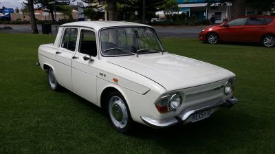 Vintage sedan with distinctive front headlights and classic 1960s design