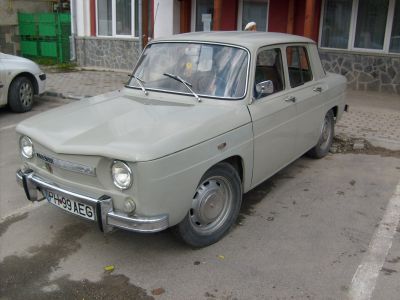 Beige classic four-door sedan with round headlights and chrome bumper